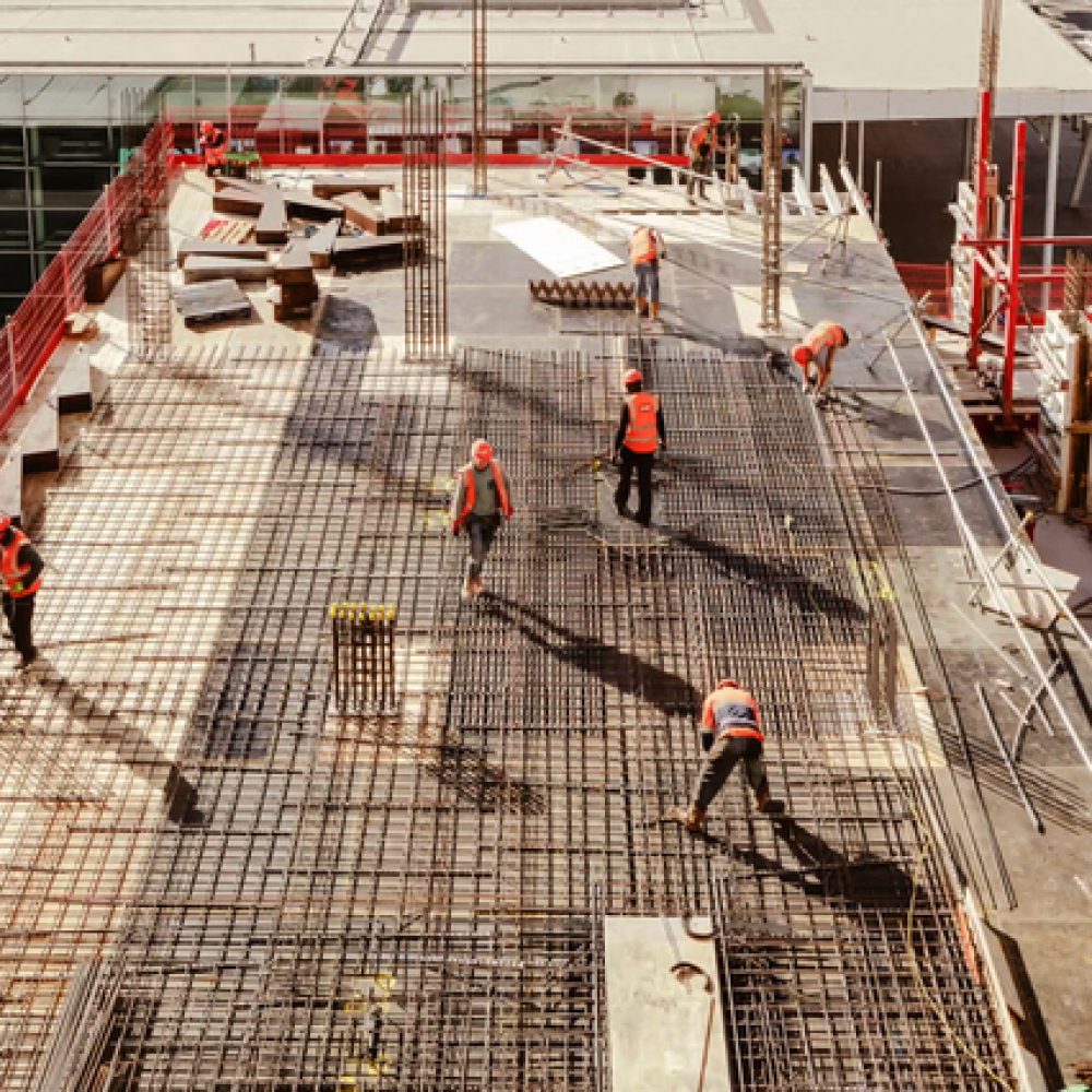 Construction workers at a construction site viewed from above, High angle view of five people with helmets.